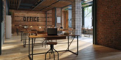 A large open office space with wooden floors and brick walls, 3d render